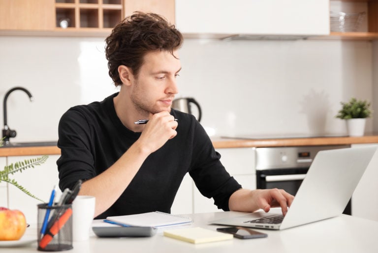 bigstock-Young-Man-Working-At-Home-Hom-357228389-768x513